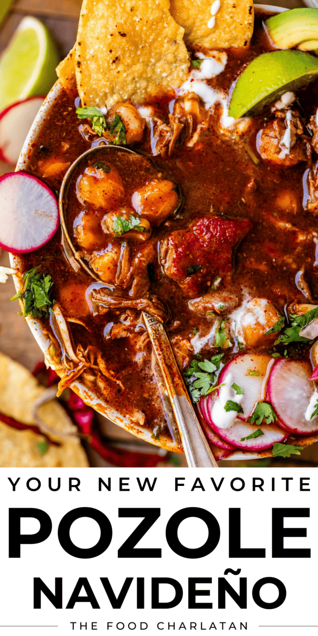 overhead picture of posole rojo in a white bowl with tostada and spoon and limes.