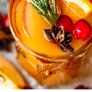 pinterest image of wassail in glass with text "perfectly spiced homemade wassail".