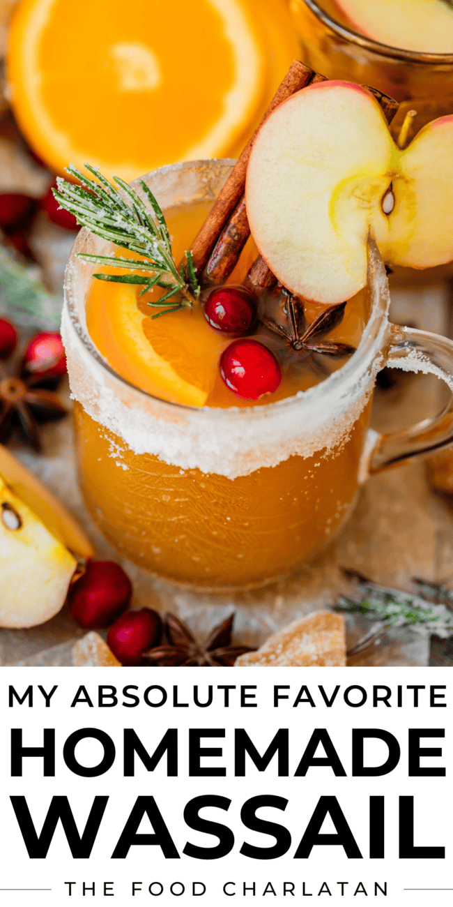 pinterest image of wassail in a sugar rimmed glass mug.