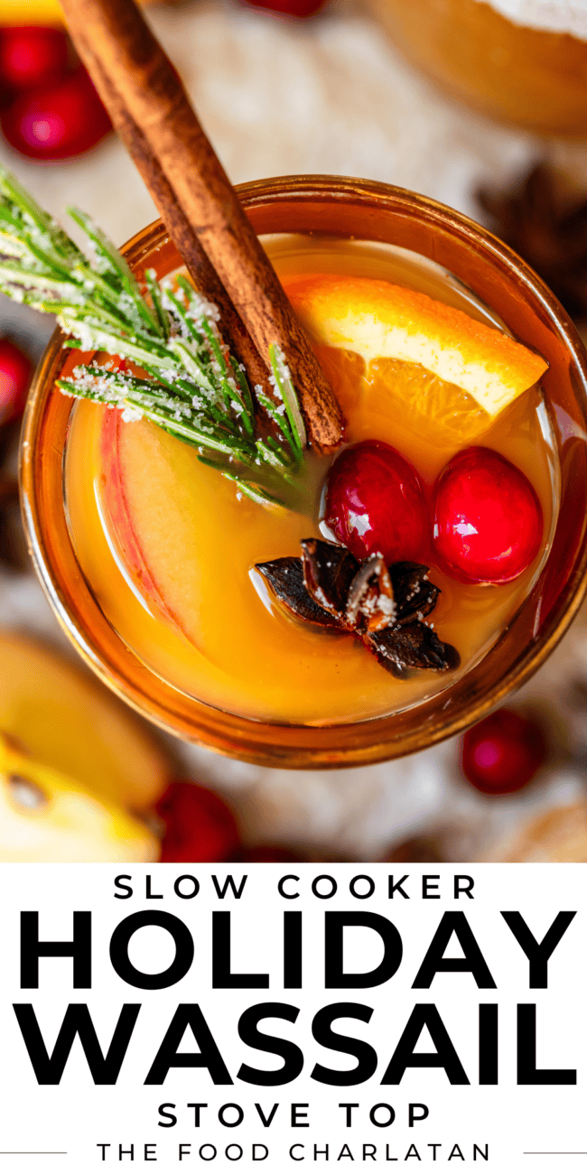 pinterest overhead image of spiced drink in a gold glass with cranberry, orange, cinnamon.