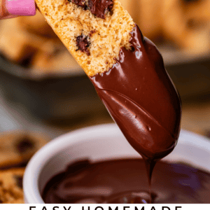 pin image of hand dipping biscotti in chocolate and text "easy homemade biscotti perfect for dipping".