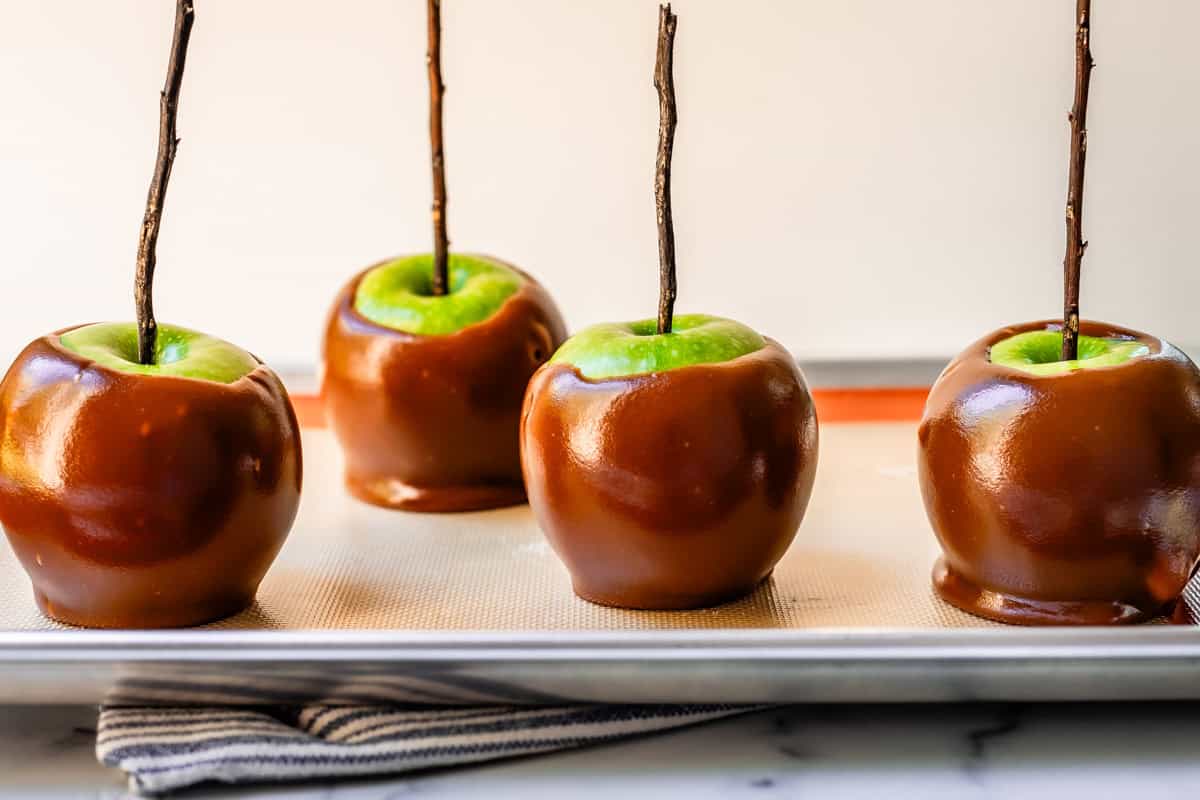 Four green caramel apples on silpat.