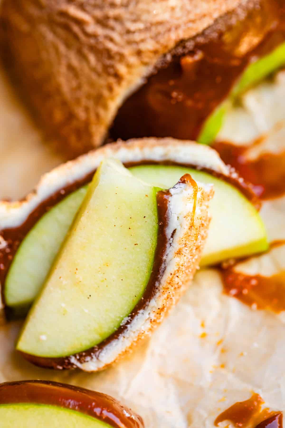 Snickerdoodle apple slices with bite taken out stacked.