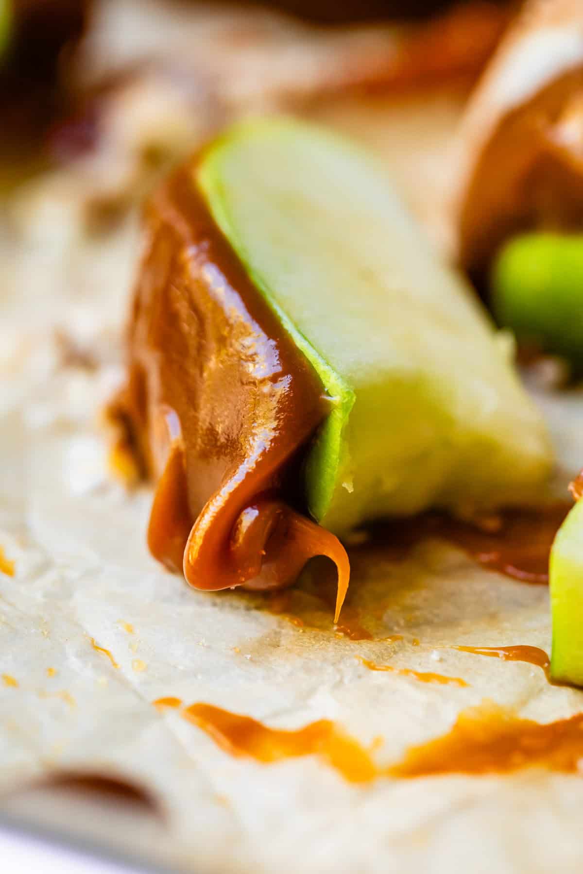 Slice of apple with gooey caramel.