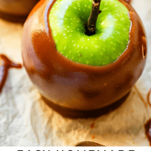 Green apple dipped in caramel with a stick in the center.