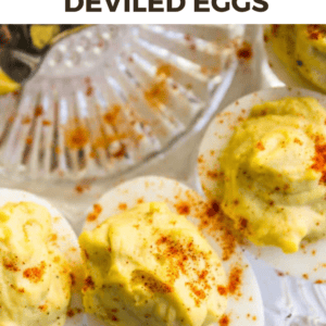 Close-up of classic deviled eggs on a glass plate, topped with a sprinkling of paprika. The text above reads Classic Deviled Eggs in bold, stylized lettering, inviting you to try this timeless deviled eggs recipe.
