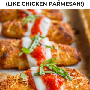Breaded fish fillets topped with melted cheese, tomato sauce, and fresh basil are arranged on a baking sheet. Text above reads, “Crispy Parmesan Fish (Like Chicken Parmesan!).”.