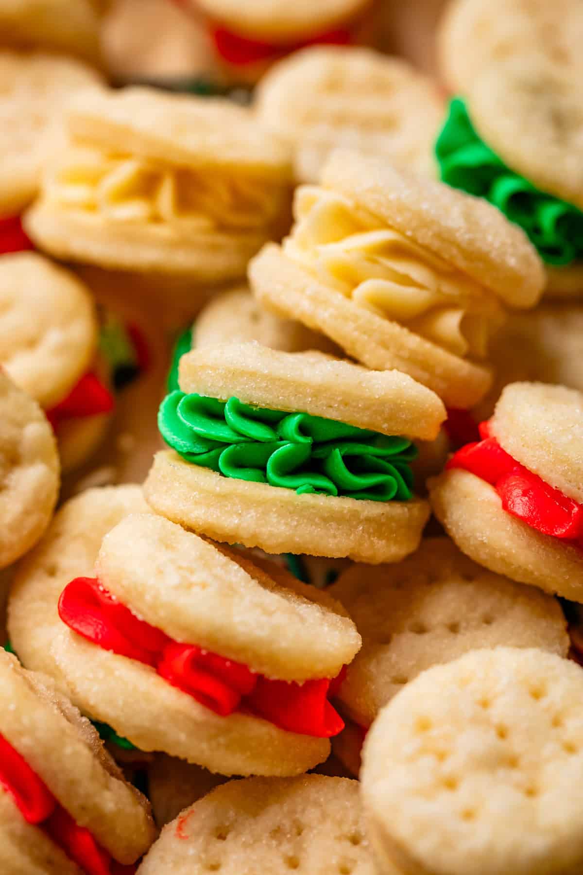 showing the side of piped frosting - red, green, and white - in cream wafer cookies.