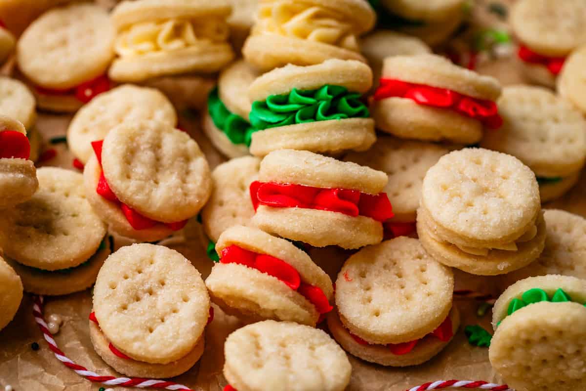 several Swedish cream wafer cookie sandwiches filled with red and green buttercream.