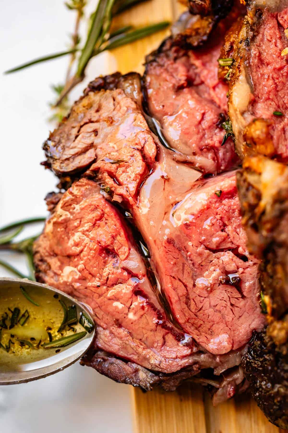 Single slice of prime rib covered in oil and garlic butter.