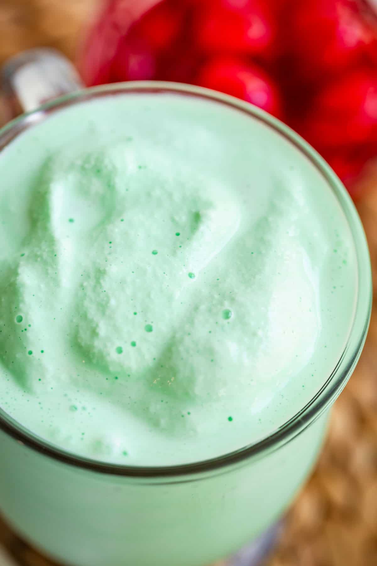 glass mug filled to the very brim with creamy shamrock shake.