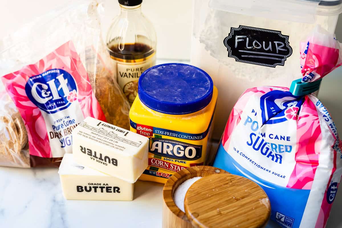 Ingredients for shortbread cookies, including butter, flour, sugar, and more.