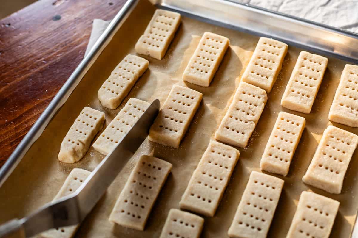 tapping the edge of almost totally baked cookies for cleaner sides and edges.