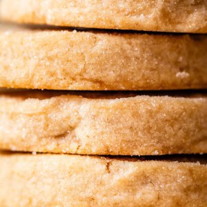 very close up shot of the side of round shortbread cookies to show thickness.