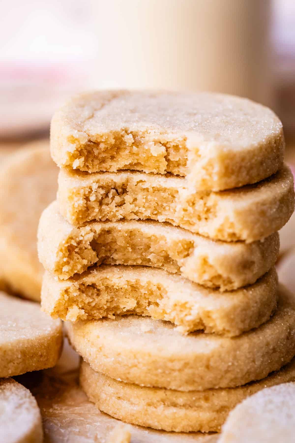 stack of shortbread cookies each with a bite taken out to show the center.