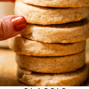 fingers pulling at stack of round shortbread cookies.