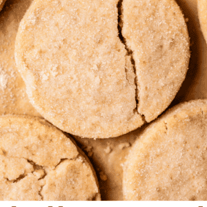 pin image with overhead shot of round shortbread cookie with crack down the side.