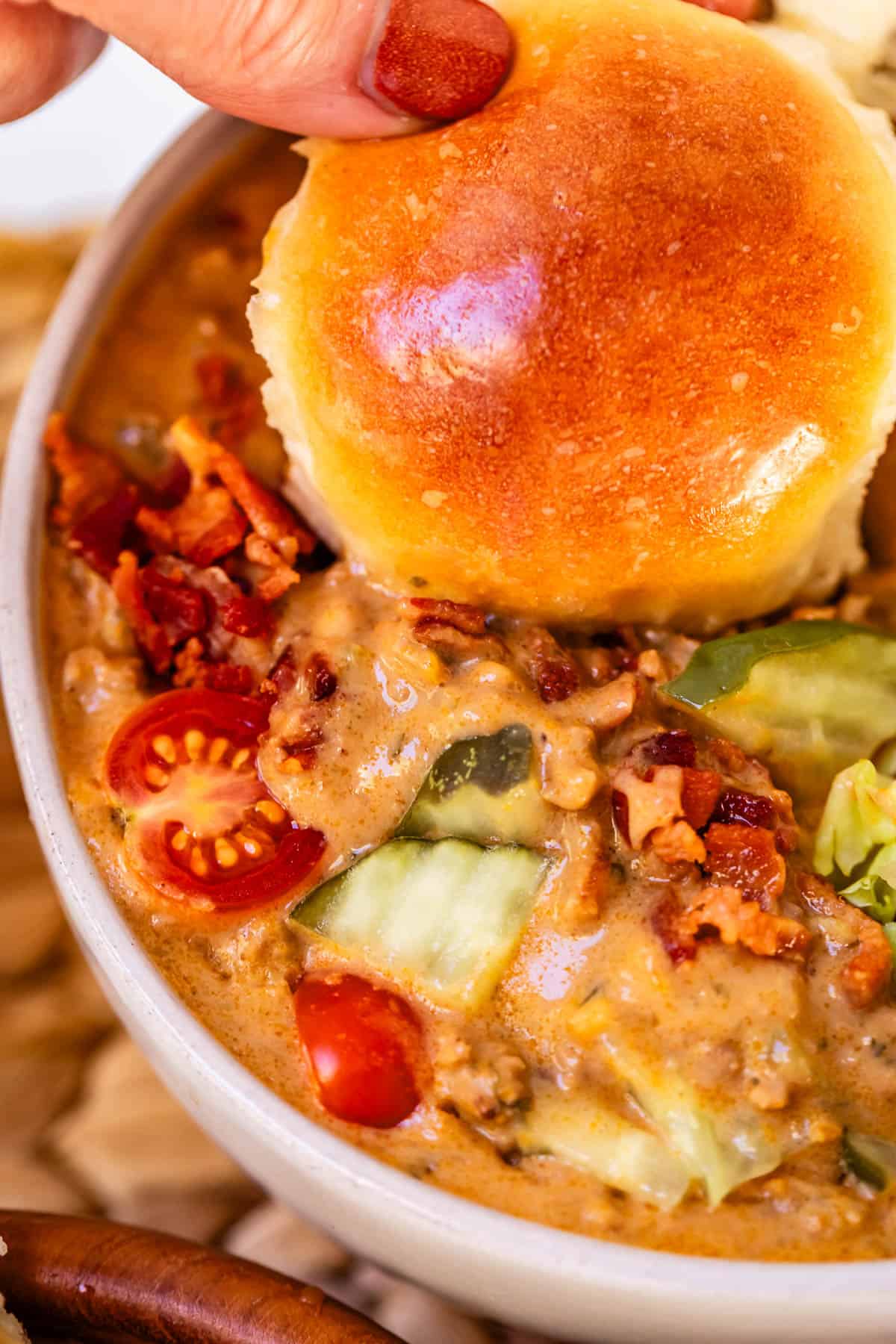 cheeseburger soup with a buttery dinner roll.