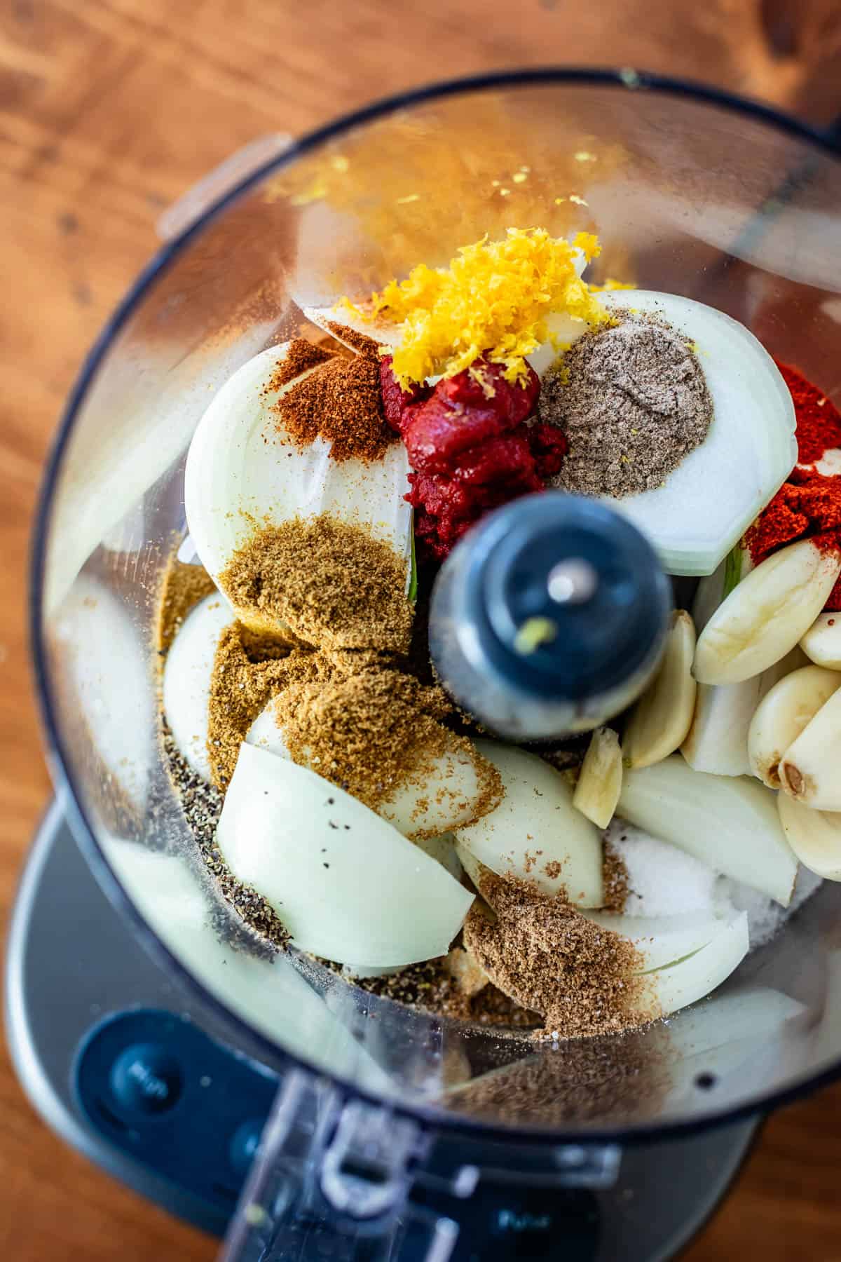 food processor filled with onions, garlic, and spices for shawarma marinade.