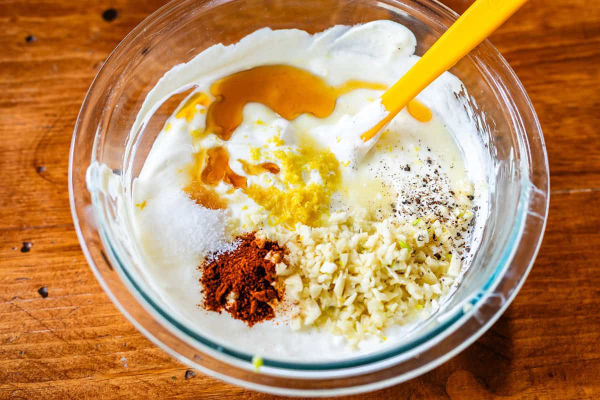 white garlic sauce ingredients in bowl - mayo, greek yogurt, garlic, and spices.