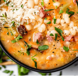 pinterest image of bowl of soup with text "homemade ham bean soup".
