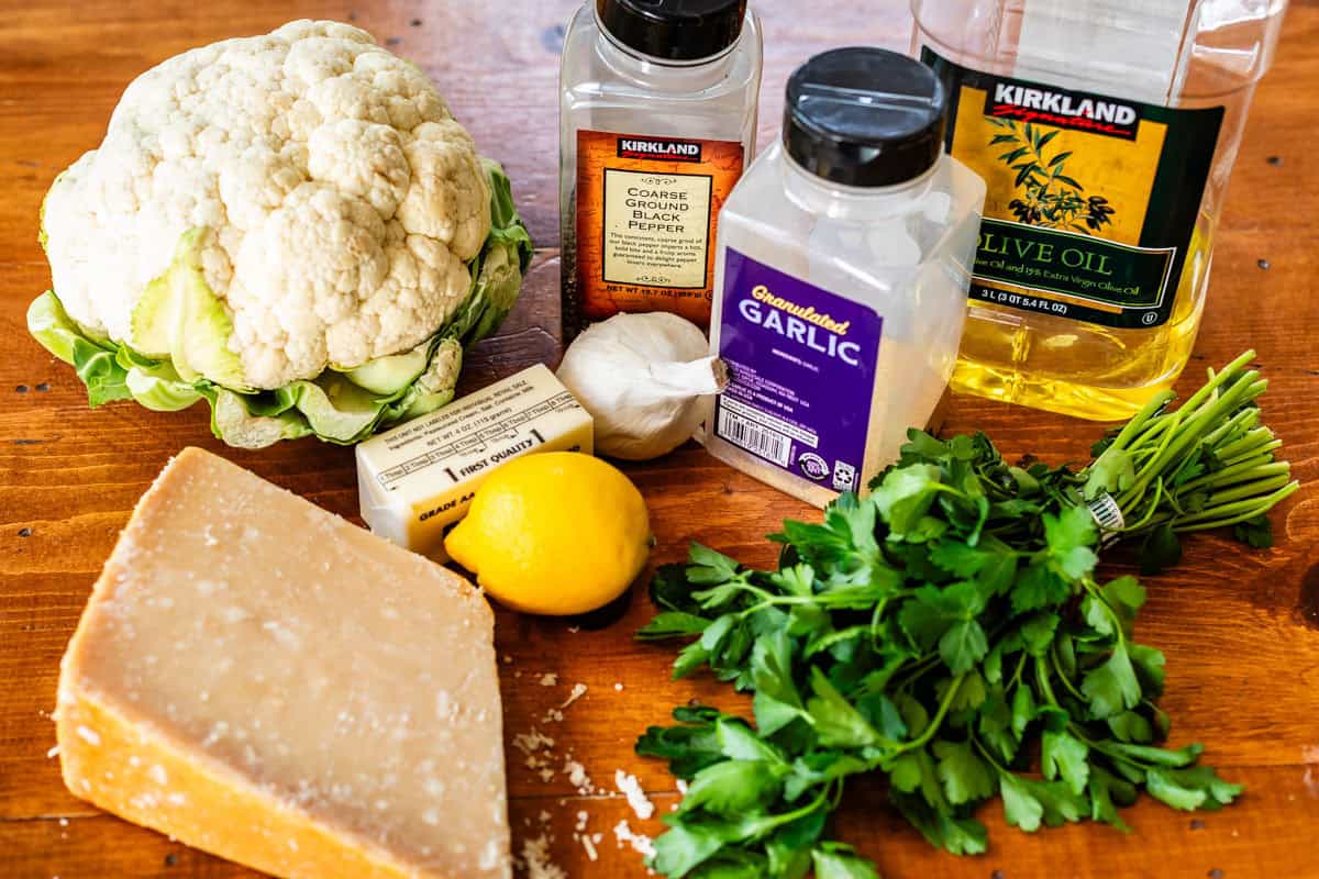 ingredients for roasted cauliflower like parmesan, butter, lemon, garlic, and more.