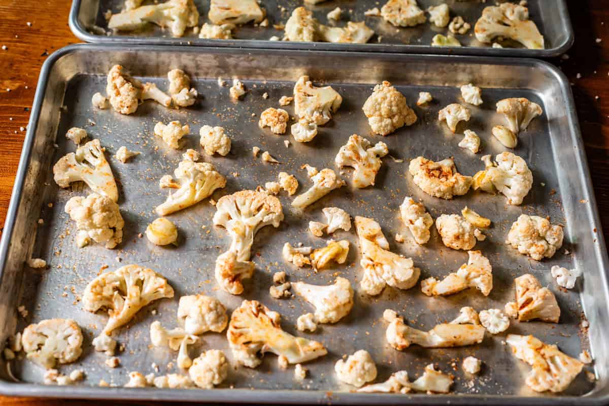 seasoned cauliflower pieces very spread out over two sheet pans.
