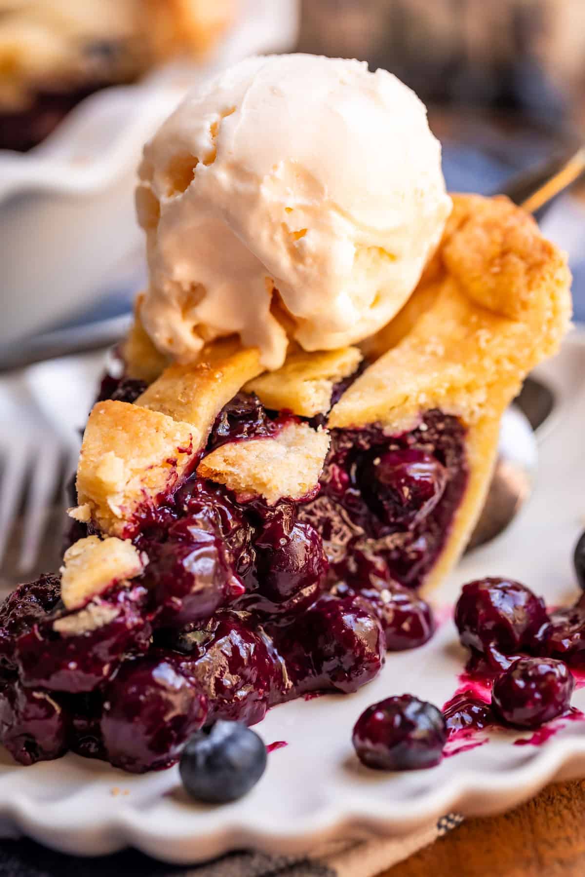 piece os blueberry pie with ice cream on top.