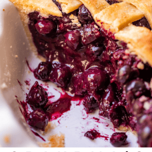 blueberry pie with berries on top in the pie pan.