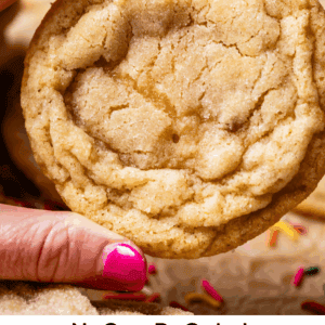 pinterest image of hand holding sugar cookie with text "no roll sugar cookies done in 30 minutes".