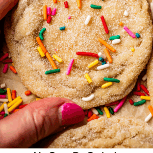 pinterest image of hand holding sugar cookie with text "no roll sugar cookies done in 30 minutes".