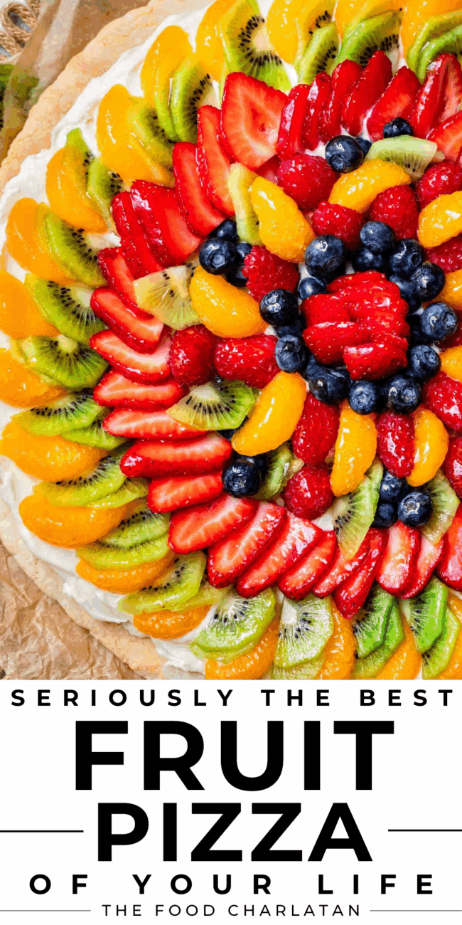 overhead shot of fruit pizza with strawberries, blueberries, kiwi, etc.