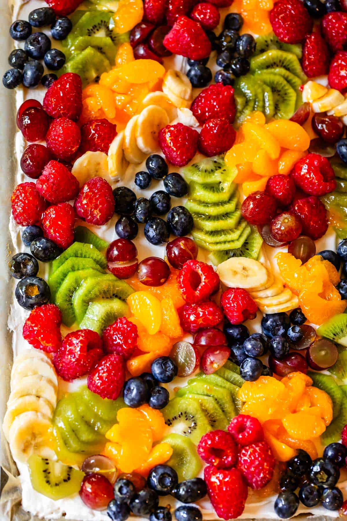 looking straight down at a rectangular fruit pizza that looks like a charcuterie board.