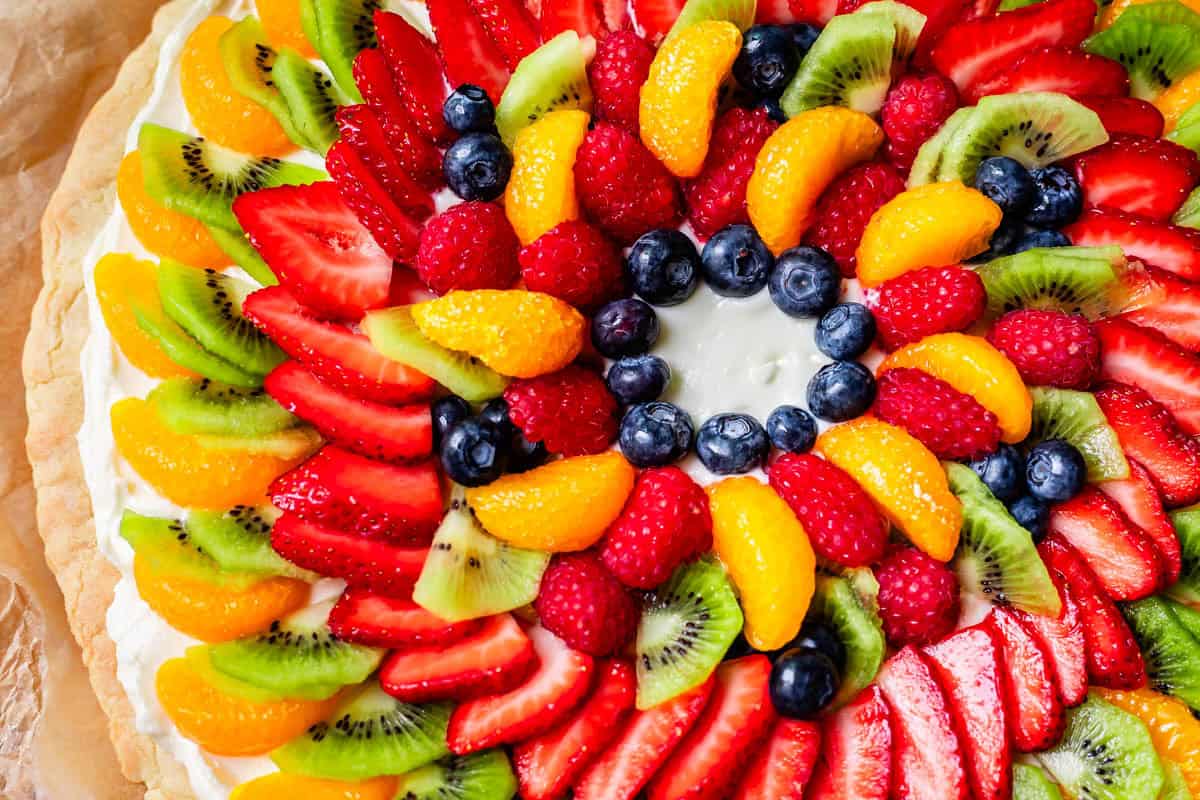 overhead shot of fruit pizza with a blank circle section in the middle with nothing there.