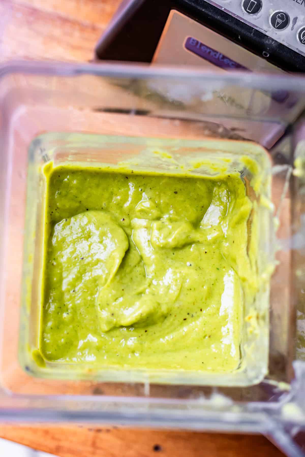 looking straight down into a blender with blended green enchilada sauce.