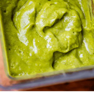 pinterest image of green sauce in a blender with text "green enchilada sauce".