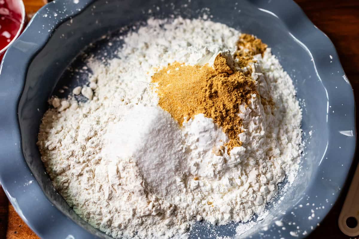 flour and cornstarch mixture for dredging chicken in a ceramic pie plate.