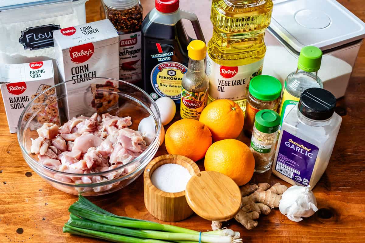 ingredients for Asian orange chicken like chicken thighs, cornstarch, oranges, and more.