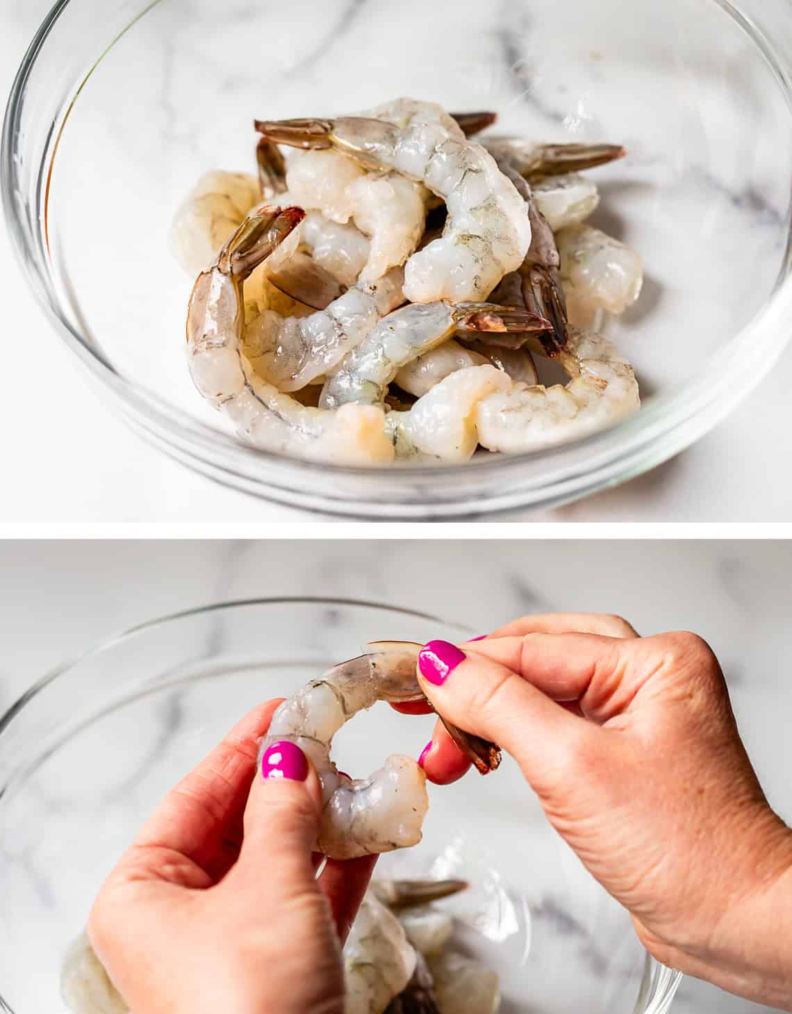 hands removing a tail from a raw shrimp, shrimp in a glass bowl.