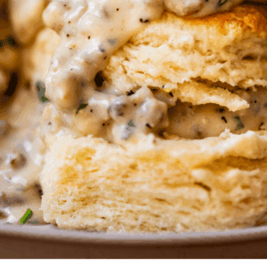 pinterest image of gravy over biscuits with text "homemade biscuits & gravy".