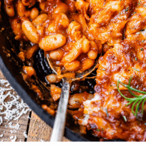 pinterest image of beans in a pan with text "quick & easy cheesy beans".