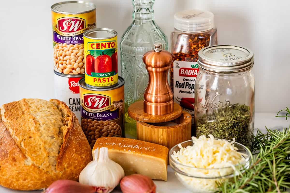 ingredients for cheesy white bean tomato bake like beans, cheese, seasonings, and more.