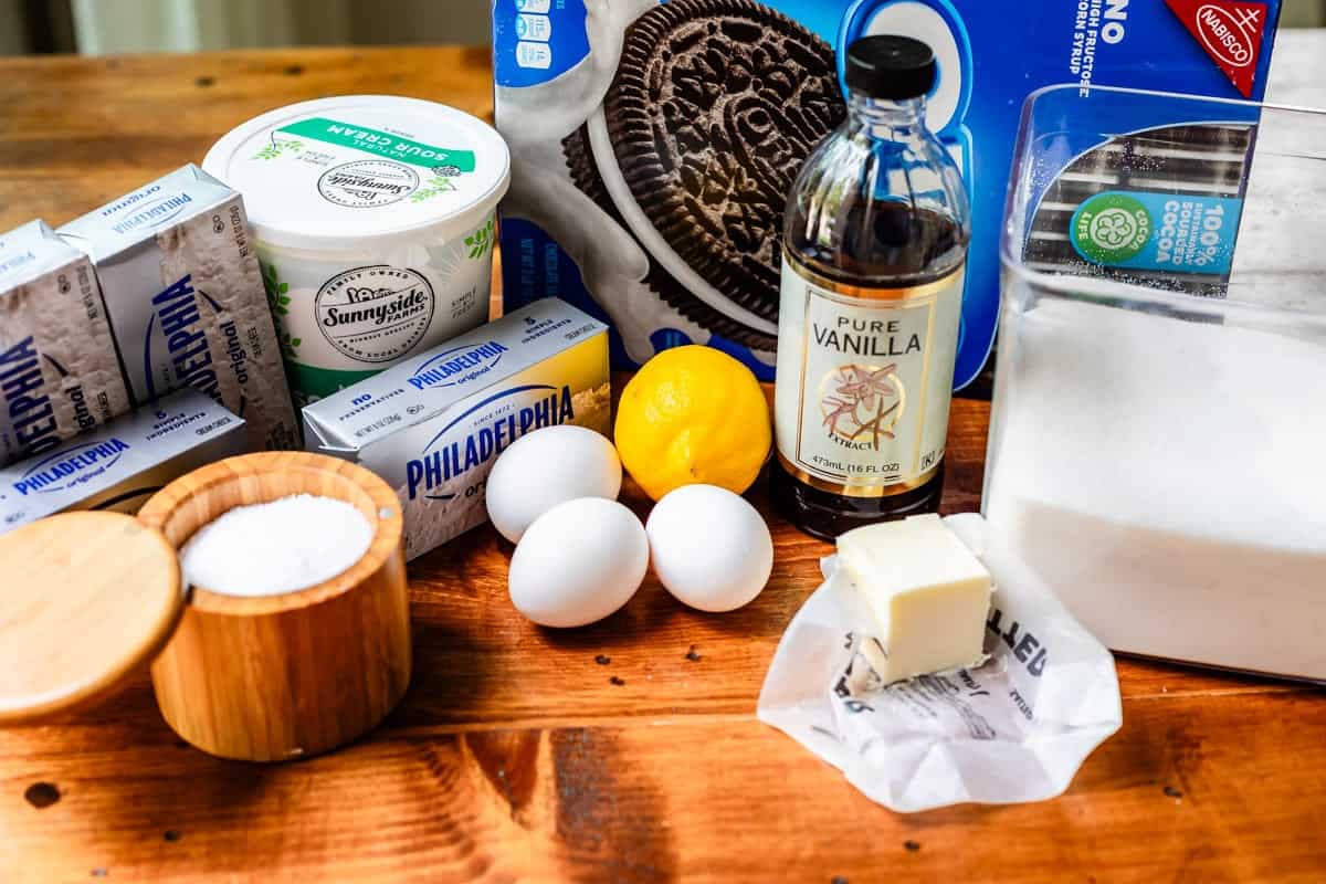 ingredients for oreo cheesecake like cream cheese, oreos, eggs, sugar, and more.