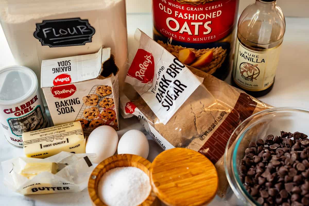 ingredients to make oatmeal chocolate chip cookies like flour, butter, sugar, and more.