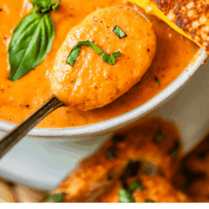 pinterest image of tomato soup with text "tomato bisque soup".