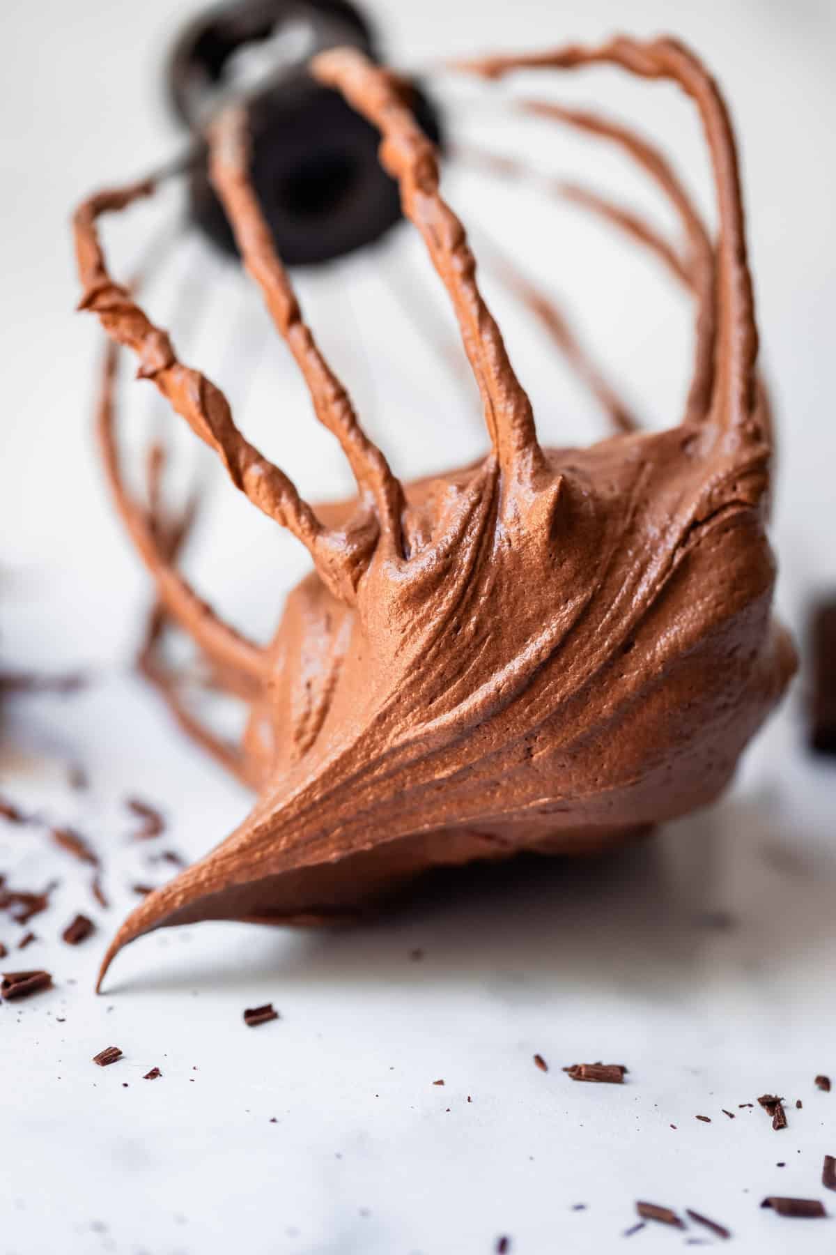 creamy chocolate frosting on the end of a whisk attachment off the mixer.