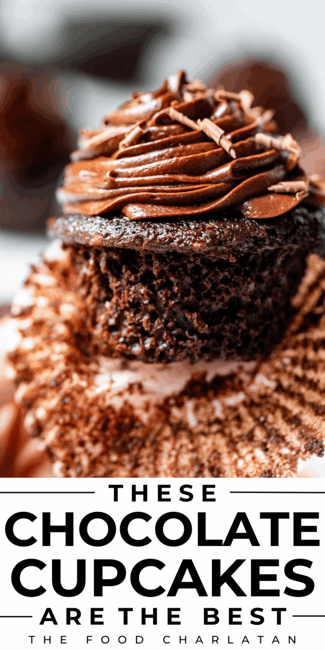 unwrapped chocolate cupcake with chocolate frosting and chocolate shavings.