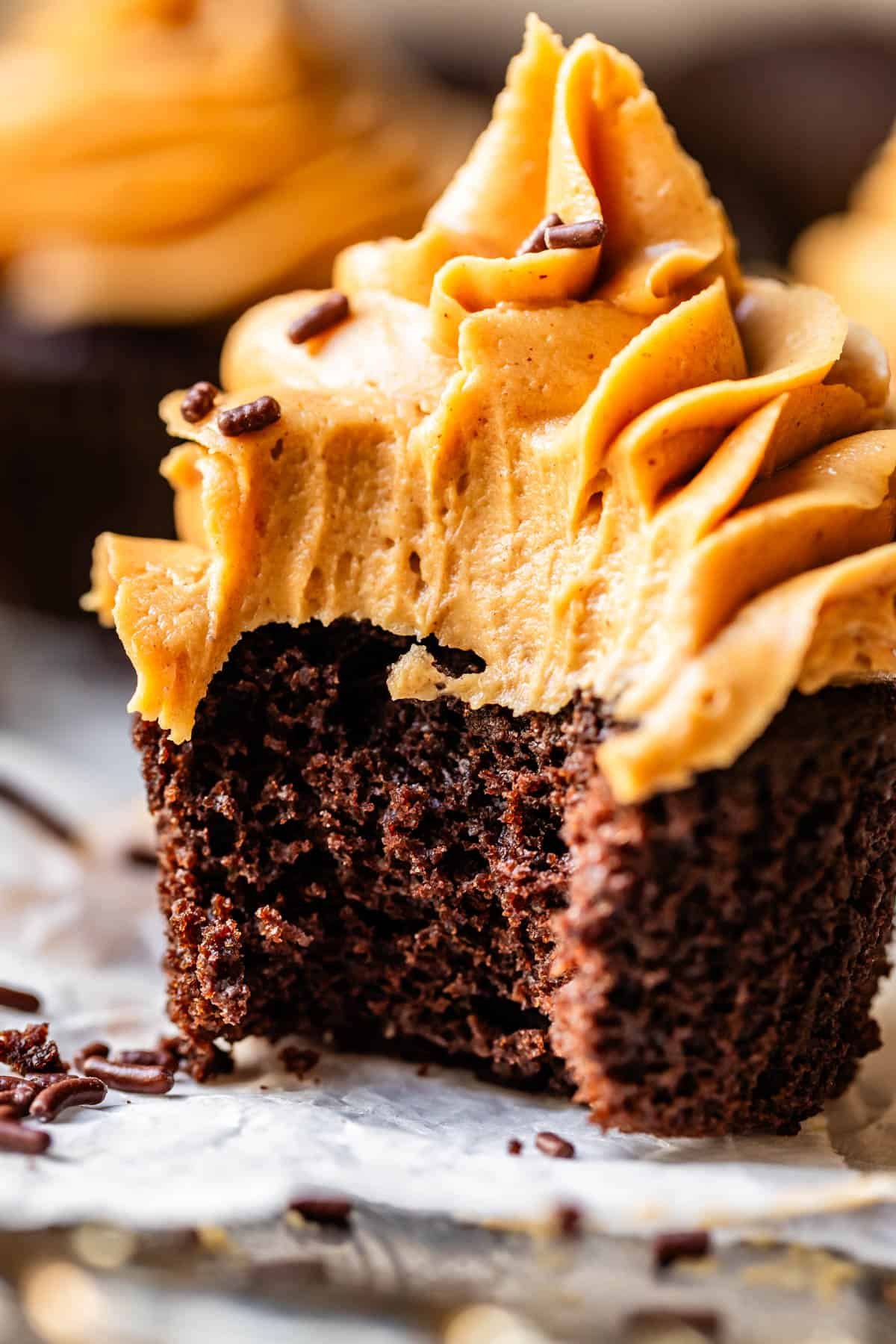 chocolate cupcake with peanut butter frosting with a bite taken out.