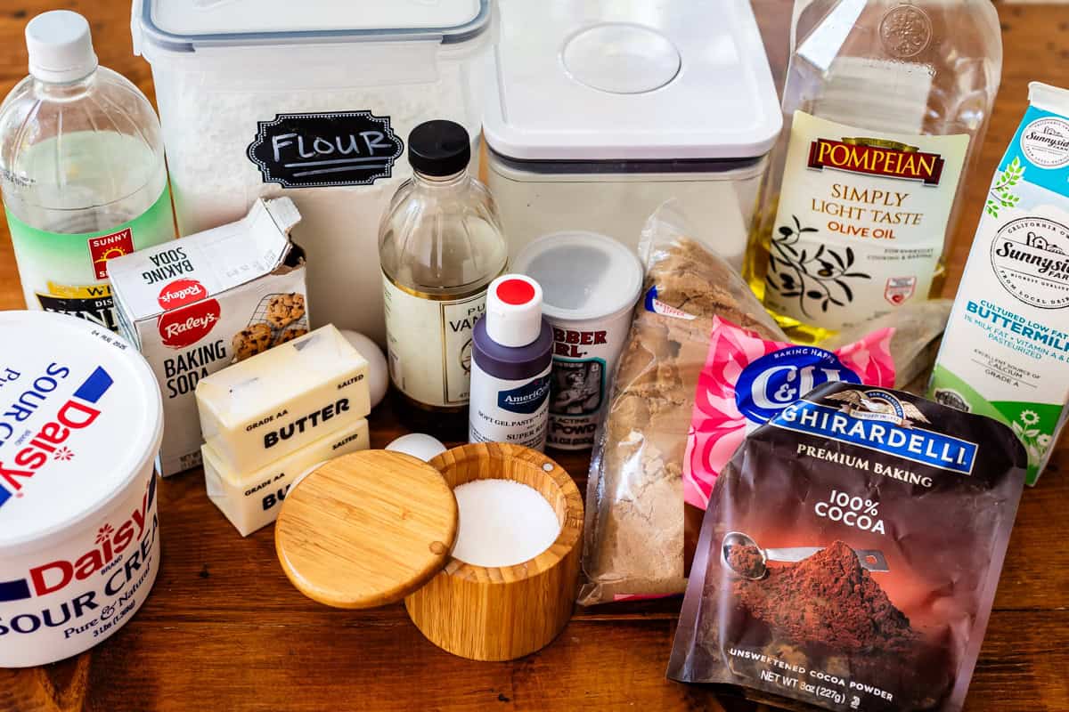 ingredients for red velvet cake like butter, sour cream, cocoa powder, and more.