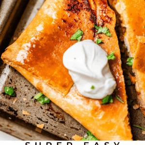 Close-up of a golden, crispy quesadilla on a sheet pan, topped with a dollop of sour cream, chopped cilantro, and a lime wedge on the side. Text at the bottom reads Super Easy Chicken Sheet Pan Quesadillas.